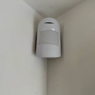 Ajax alarm installed in Rotherham by Above Security. Image is of a white internal PIR.